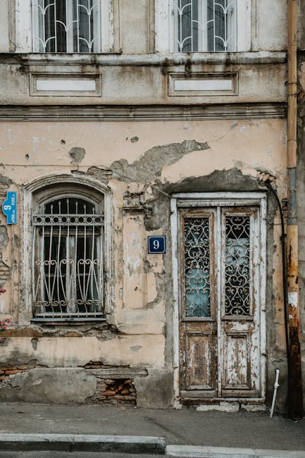 5 : img_3 - Weathered building facade with number 9 plaque